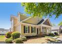 Charming home with yellow siding, black shutters, and a well-maintained front yard at 140 Campaign Trl, Fayetteville, GA 30214