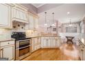Bright kitchen featuring custom cabinets, granite countertops, and stainless steel appliances at 140 Campaign Trl, Fayetteville, GA 30214