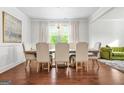 Elegant dining room with hardwood floors, chandelier, and views of a living area at 130 Sycamore Row, South Fulton, GA 30331