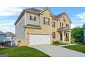Beautiful home featuring a two-car garage, brick accents, and landscaped front yard at 130 Sycamore Row, South Fulton, GA 30331