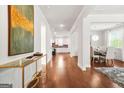 Bright entryway features gleaming hardwood floors and a view into the kitchen and dining area at 130 Sycamore Row, South Fulton, GA 30331