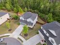 Aerial view of a gray two-story home in a quiet neighborhood at 1953 Azure Grove Ct, Marietta, GA 30008