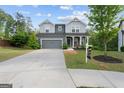 Traditional home with a long drive way and 'For Sale' sign on a lush green lawn at 1953 Azure Grove Ct, Marietta, GA 30008