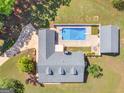 Bird's-eye view of a home featuring a private pool, detached garage, and serene backyard oasis at 421 Hampton Rd, Fayetteville, GA 30215