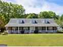 Beautiful brick home with a classic front porch and manicured landscaping, perfect for curb appeal at 421 Hampton Rd, Fayetteville, GA 30215
