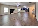 Spacious living room featuring a fireplace, hardwood floors, and an open floor plan at 143 Tara Blvd, Loganville, GA 30052