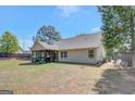 Spacious backyard featuring a screened-in porch, lush lawn, and mature trees creating a serene outdoor space at 103 Fuller Ct, Grantville, GA 30220