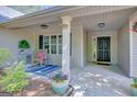 Inviting covered front porch with seating and decorative plants, enhancing the home's curb appeal at 103 Fuller Ct, Grantville, GA 30220