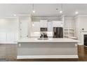 Bright kitchen with white cabinets, a center island, stainless steel appliances, and hardwood floors at 1106 Bakary Ct, Decatur, GA 30032
