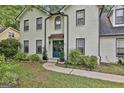 Beautiful home featuring a teal double door entry framed by lush landscaping at 215 Calgary Dr., Peachtree City, GA 30269