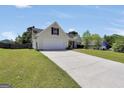 Well maintained one story home with a long driveway and well manicured lawn at 146 Calico Loop, Grantville, GA 30220