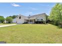 Well maintained one story home with a long front lawn and well manicured bushes at 146 Calico Loop, Grantville, GA 30220
