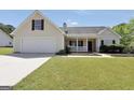 Charming one story home with a well manicured lawn and covered front porch during the day at 146 Calico Loop, Grantville, GA 30220
