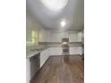 Well-lit kitchen with modern stainless steel appliances and granite countertops at 147 Tara Blvd, Loganville, GA 30052
