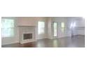 Bright living room with a fireplace and large windows allowing for abundant natural light at 147 Tara Blvd, Loganville, GA 30052
