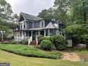 Charming two-story home featuring a welcoming porch and beautifully landscaped front yard at 332 Wyngate Rd, Auburn, GA 30011