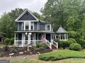 Charming two-story home featuring a welcoming porch and beautiful front yard landscaping at 332 Wyngate Rd, Auburn, GA 30011
