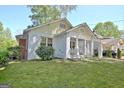 Charming home with brick and siding, a front porch, and porte-cochere, on a verdant lawn at 78 Atlanta Se Ave, Atlanta, GA 30315
