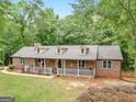 Aerial view showcases this beautiful single Gathering home, nestled among mature trees on a spacious lot at 930 Singley Dr, Locust Grove, GA 30248