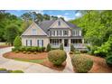 Charming two-story home featuring a welcoming front porch and meticulous landscaping at 105 Riviera Ct, Fayetteville, GA 30215
