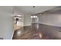 Open-concept living room showcasing hardwood floors, modern lighting, and a view into the kitchen at 321 Shadowbrooke Dr, Loganville, GA 30052