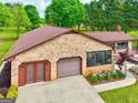 A lovely brick home featuring a garage and a screened-in porch with manicured flowerbeds at 171 Wynn Dr, Hampton, GA 30228
