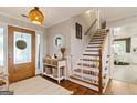 Welcoming foyer featuring hardwood floors, open staircase, and decorative furnishings at 139 Crown Forest Dr, Mcdonough, GA 30252