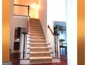 Carpeted staircase featuring wood railings and views into other rooms at 30 Cynthia Ct, Fayetteville, GA 30215