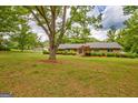 Well-maintained brick home with mature landscaping, including a vibrant Japanese maple tree at 110 Silver Leaf Dr, Fayetteville, GA 30214