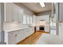 Bright kitchen with white cabinets, subway tile backsplash, and stainless steel appliances at 19 Mcdonough St, Hampton, GA 30228