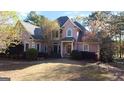 Stately two-story brick home with lush landscaping and a circular driveway at 8040 Classic Dr, Jonesboro, GA 30236