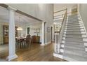 Open foyer with hardwood floors, staircase, and views into the dining room at 8040 Classic Dr, Jonesboro, GA 30236