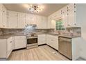 Bright kitchen featuring stainless steel appliances, granite countertops, and ample cabinet space at 6454 Boca Grande Blvd, Forest Park, GA 30297