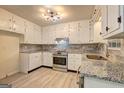 Bright kitchen featuring stainless steel appliances, granite countertops, and ample cabinet space at 6454 Boca Grande Blvd, Forest Park, GA 30297