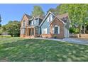 Beautiful two-story home featuring a well-maintained lawn and a driveway leading to the garage at 1310 Yarborough Dr, Peachtree City, GA 30269