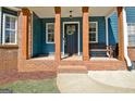 Inviting front porch featuring wooden pillars, a wreath, and a comfortable bench at 1310 Yarborough Dr, Peachtree City, GA 30269