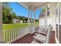 Covered porch featuring rocking chairs, offering a relaxing view of the manicured lawn and neighborhood at 190 Ridgecrest Dr, Fayetteville, GA 30215