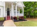 Inviting front porch with white columns and space for seating, offering a relaxing outdoor area at 190 Ridgecrest Dr, Fayetteville, GA 30215