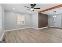 Bright and airy living space featuring wood-look floors, a ceiling fan, and a decorative wall at 3650 Adkins Nw Rd, Atlanta, GA 30331