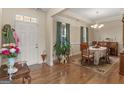 Inviting dining area with hardwood floors, a chandelier, and a decorative rug under the wooden table at 3226 Puritan Way, Mcdonough, GA 30252