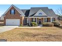 Attractive brick home showcasing a landscaped front yard and classic architectural details, including a welcoming porch at 3226 Puritan Way, Mcdonough, GA 30252