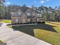 Charming two-story home featuring a mix of brick and stone, complemented by a well-kept yard at 412 Guildhouse Dr # 38, Mcdonough, GA 30252