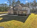 Spacious two-story home showcasing a brick and stone exterior, and well-maintained front lawn at 412 Guildhouse Dr # 38, Mcdonough, GA 30252