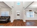 Bright foyer with hardwood floors, high ceilings, white trim, and natural light from window at 412 Guildhouse Dr # 38, Mcdonough, GA 30252