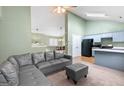 Open-concept living room with vaulted ceilings and a modern gray sofa at 470 Old Griffin Rd, Hampton, GA 30228