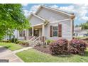 Charming home featuring a welcoming front porch, well-manicured landscaping, and classic architectural details at 175 Campaign Trl, Fayetteville, GA 30214