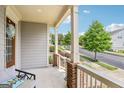 Inviting front porch with seating area and views of the surrounding neighborhood at 175 Campaign Trl, Fayetteville, GA 30214