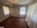 Traditional dining room with a classic chandelier, hardwood floors, and bright natural light from large windows at 1800 Austin Dr, Decatur, GA 30032