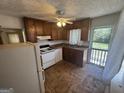 Functional kitchen featuring wood cabinets, a white appliance suite, and access to the backyard at 1800 Austin Dr, Decatur, GA 30032
