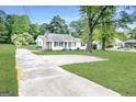 Exterior shot of a single Gathering house with a long driveway and a spacious green yard at 1236 Stone Mountain Lithonia Rd, Lithonia, GA 30058